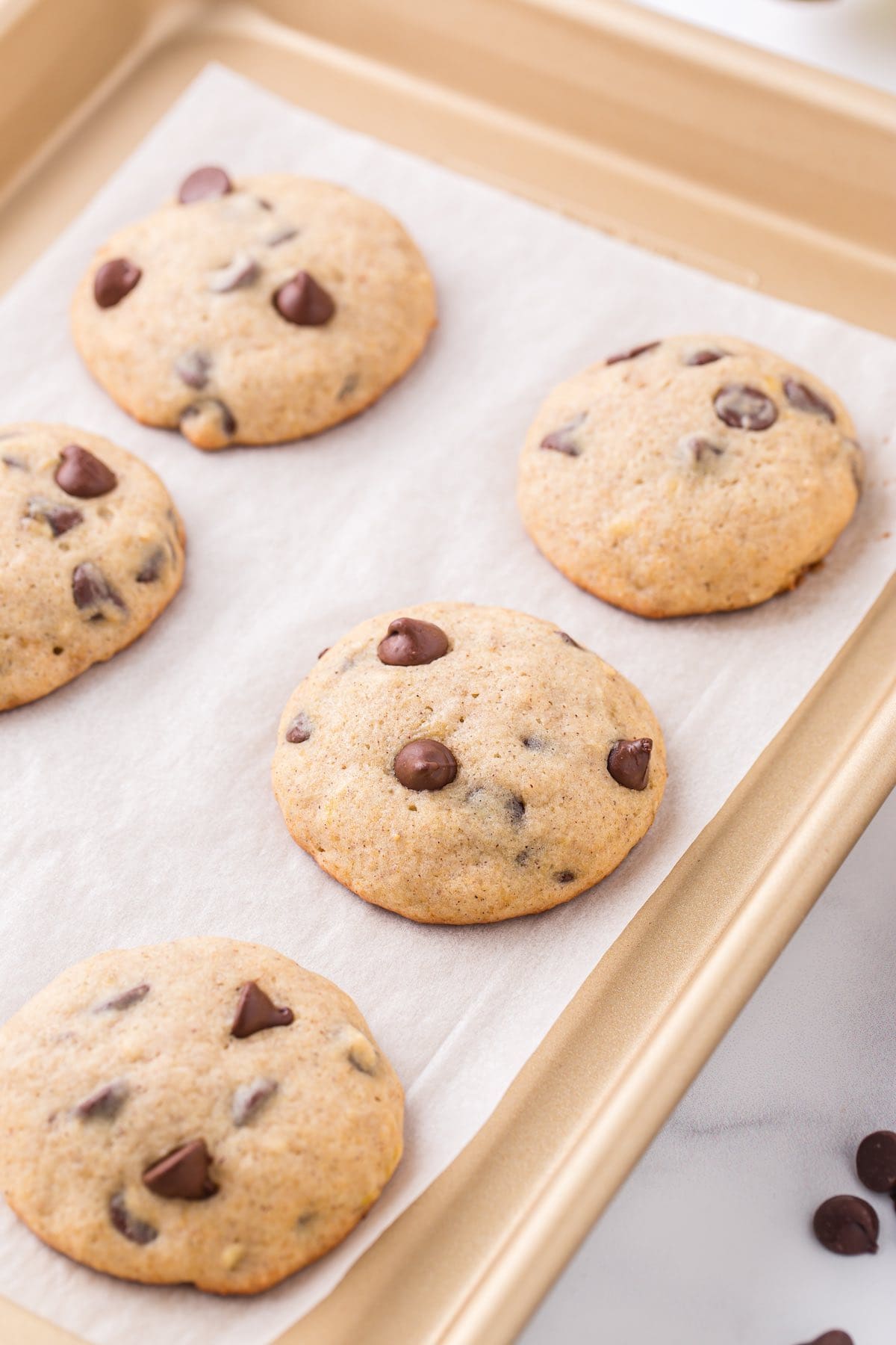 a couple banana bread cookies on top of baking tray. 