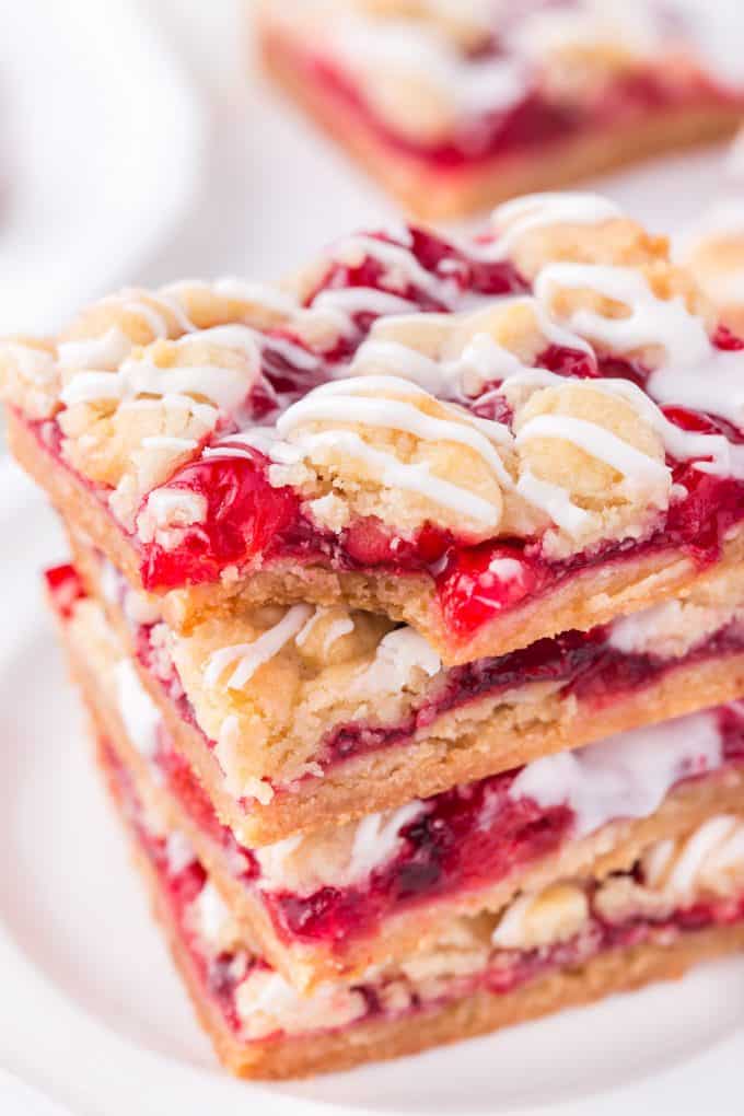 cherry pie bars stacked with a bite