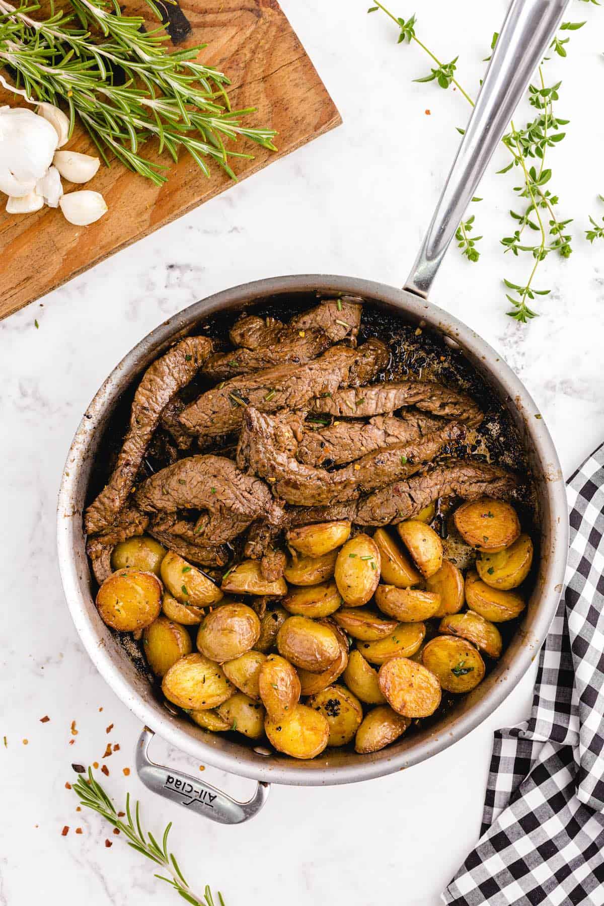 potato and steak in a skillet