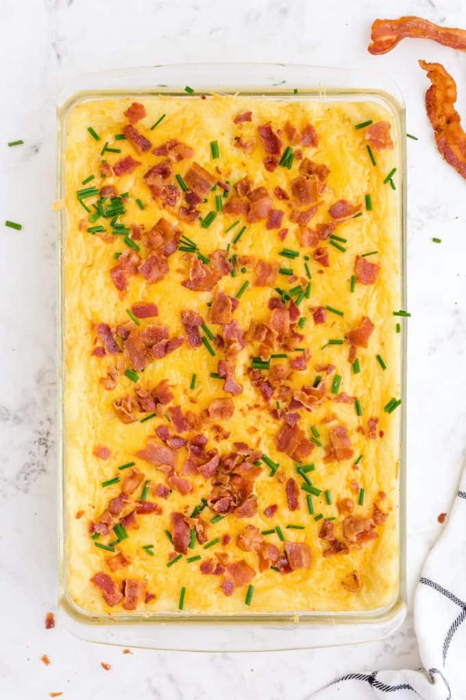 mashed potato casserole topped with bacon and chives