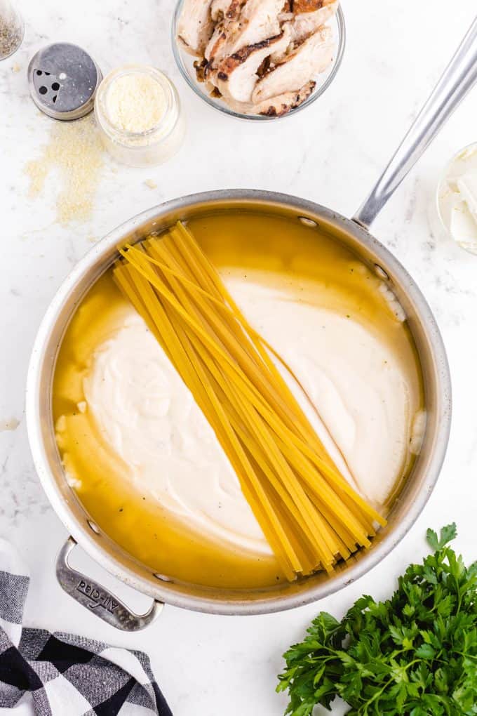 pot with Alfredo sauce and pasta