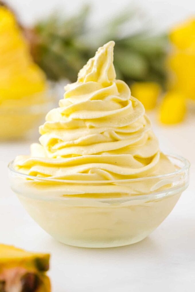 Dole Whip Disney in a bowl with pineapple in the background
