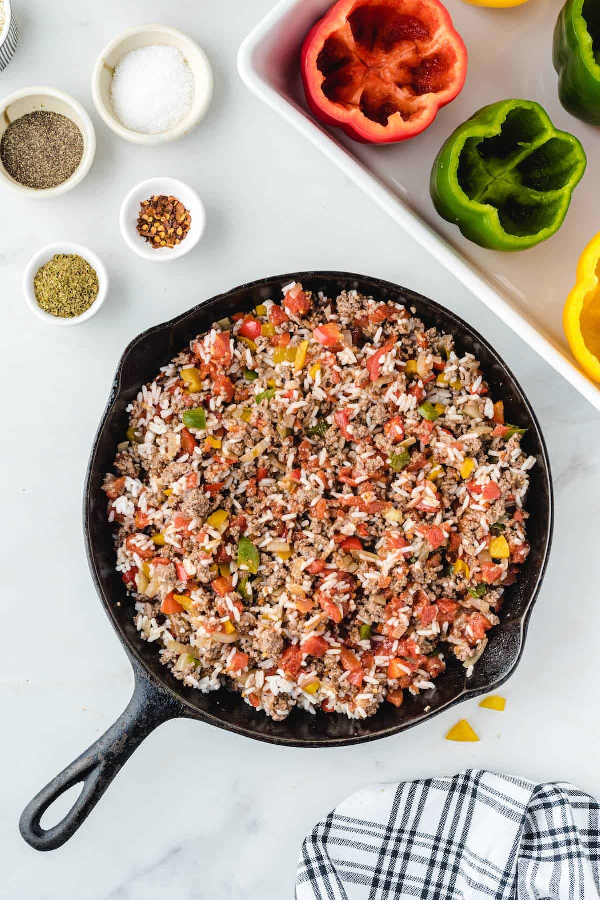 mixture of diced bell peppers, ground beef, rice in a pan
