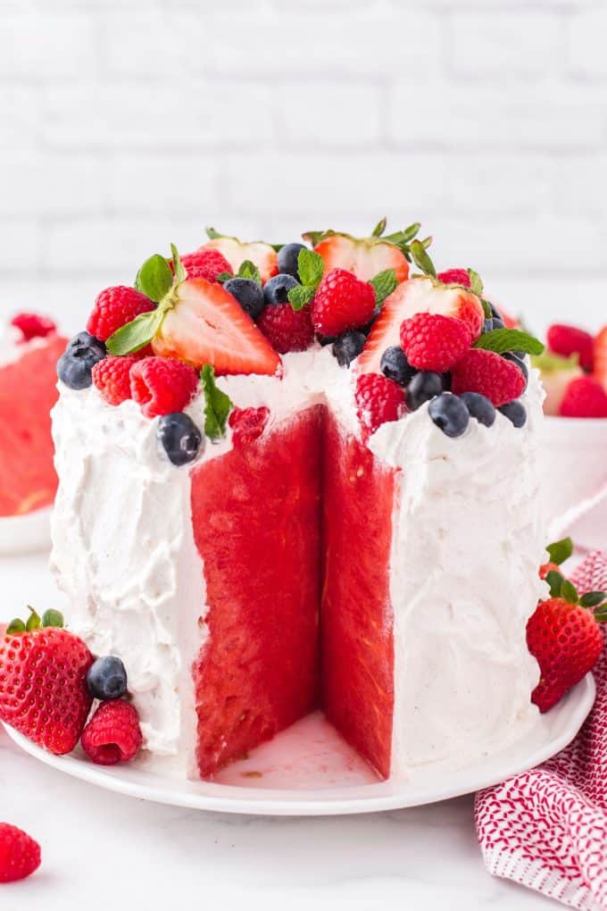 fresh watermelon cake topped with strawberries and blueberries