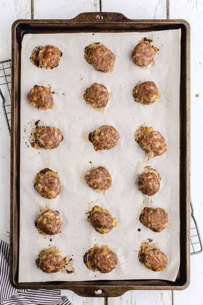 baked meatballs lined up in the baking tray