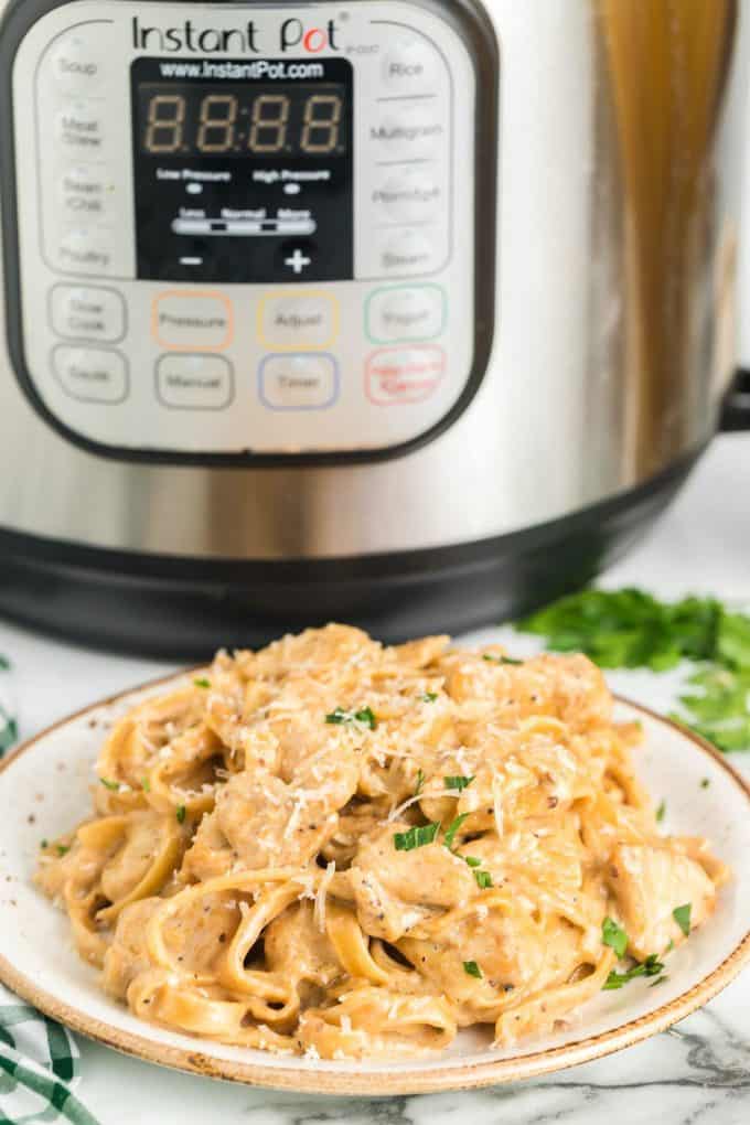 chicken alfredo with instant pot in the background