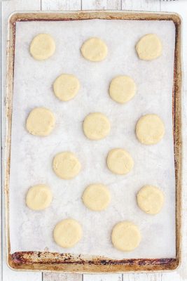ball shaped dough on top of cookie baking sheet