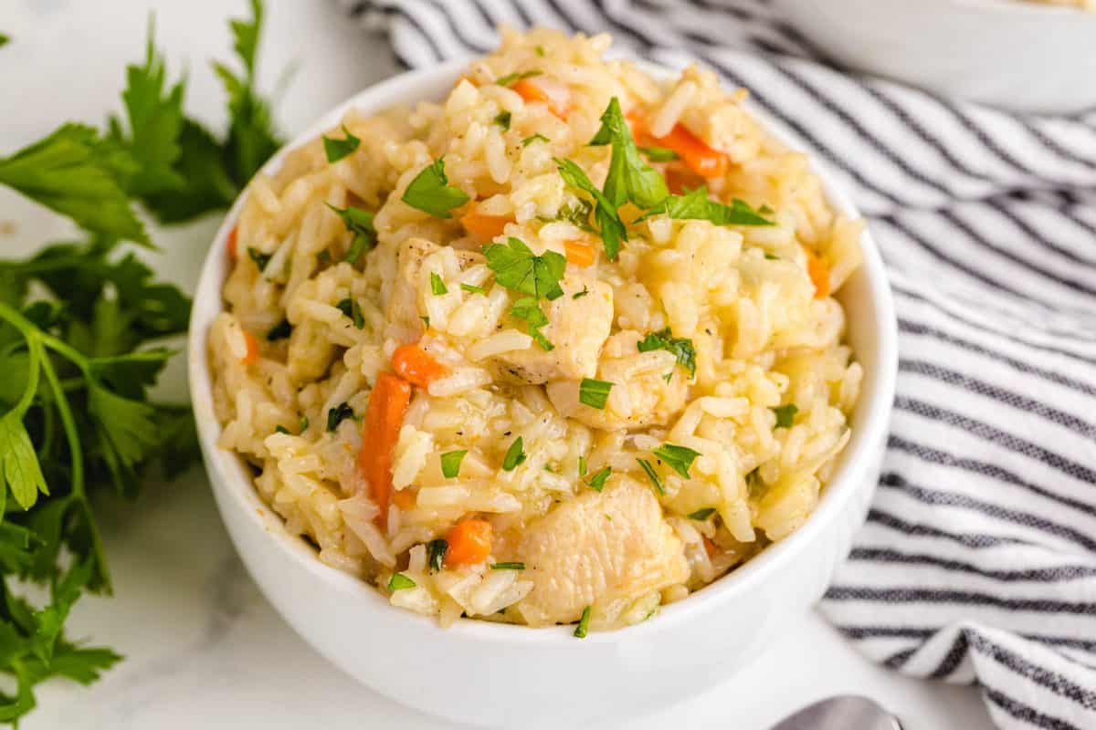 Chicken and rice in a white bowl.
