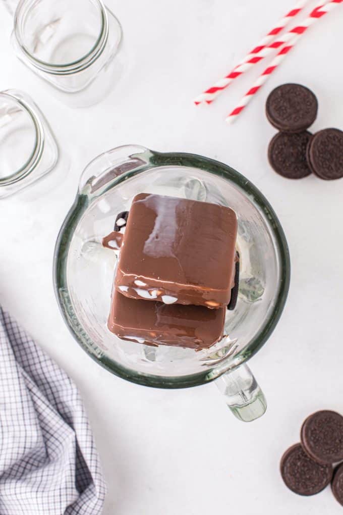 Place Klondike bars, Oreos, ice, vanilla, and half & half in a blender