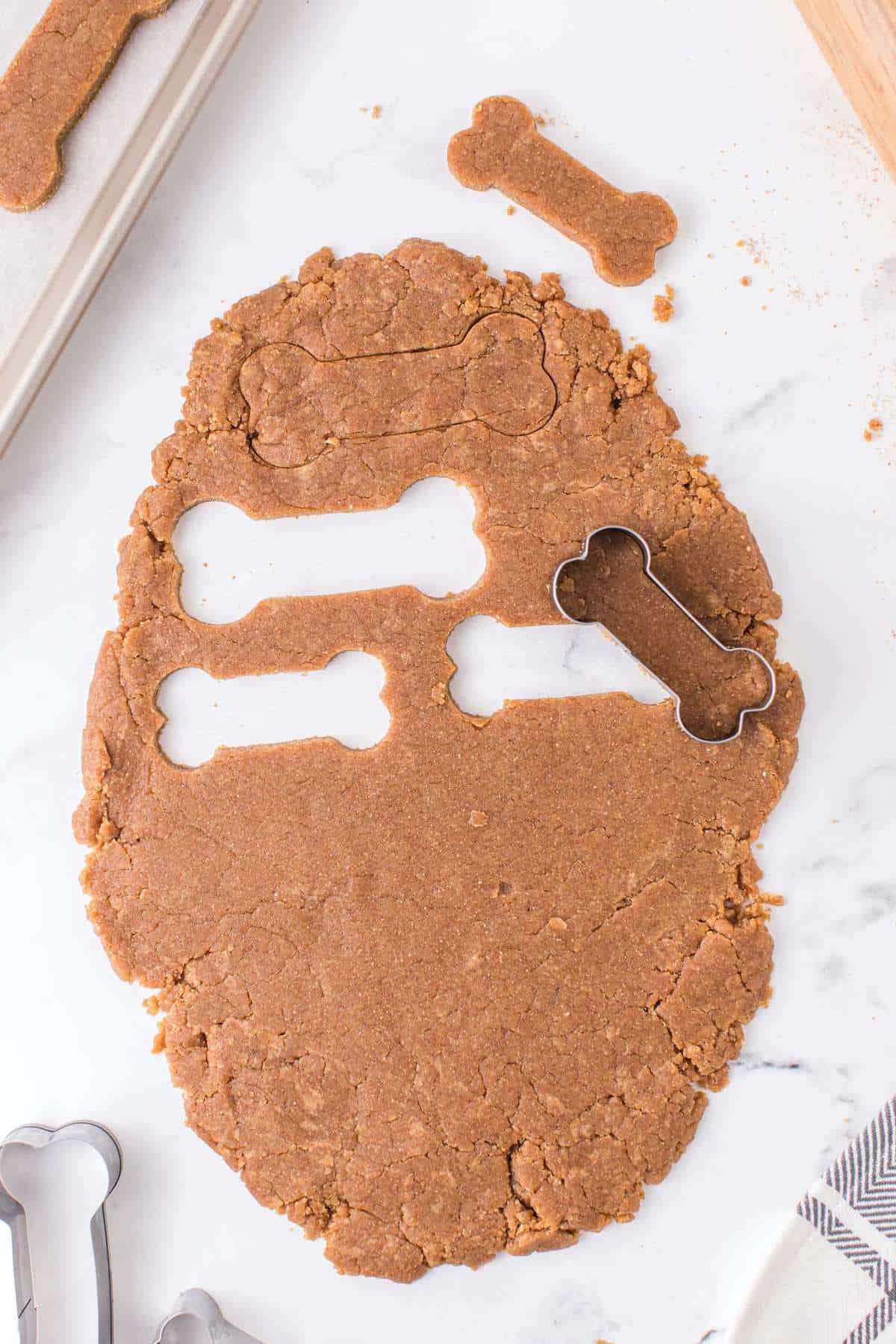 cut cookies using dog-inspired cookie cutter
