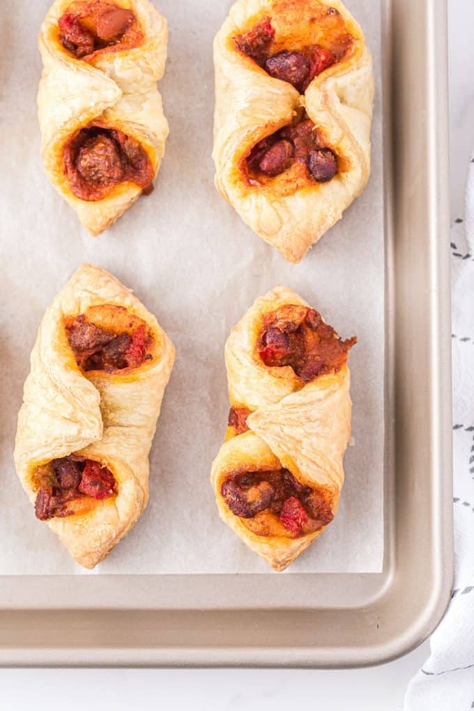 4 puffy tacos in a baking sheet