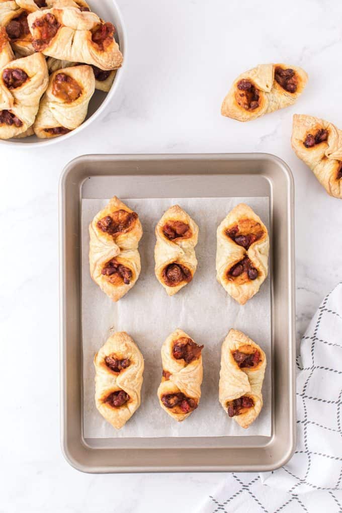 6 puffy tacos in a baking sheet