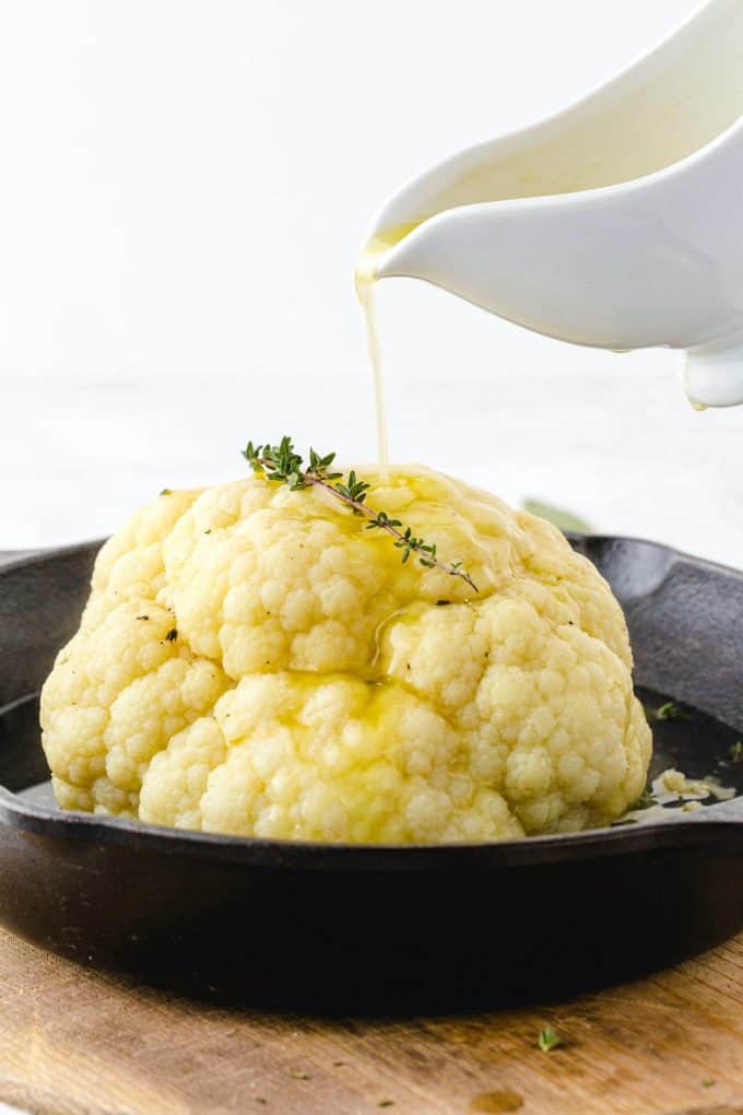 pouring melted butter into the cauliflower