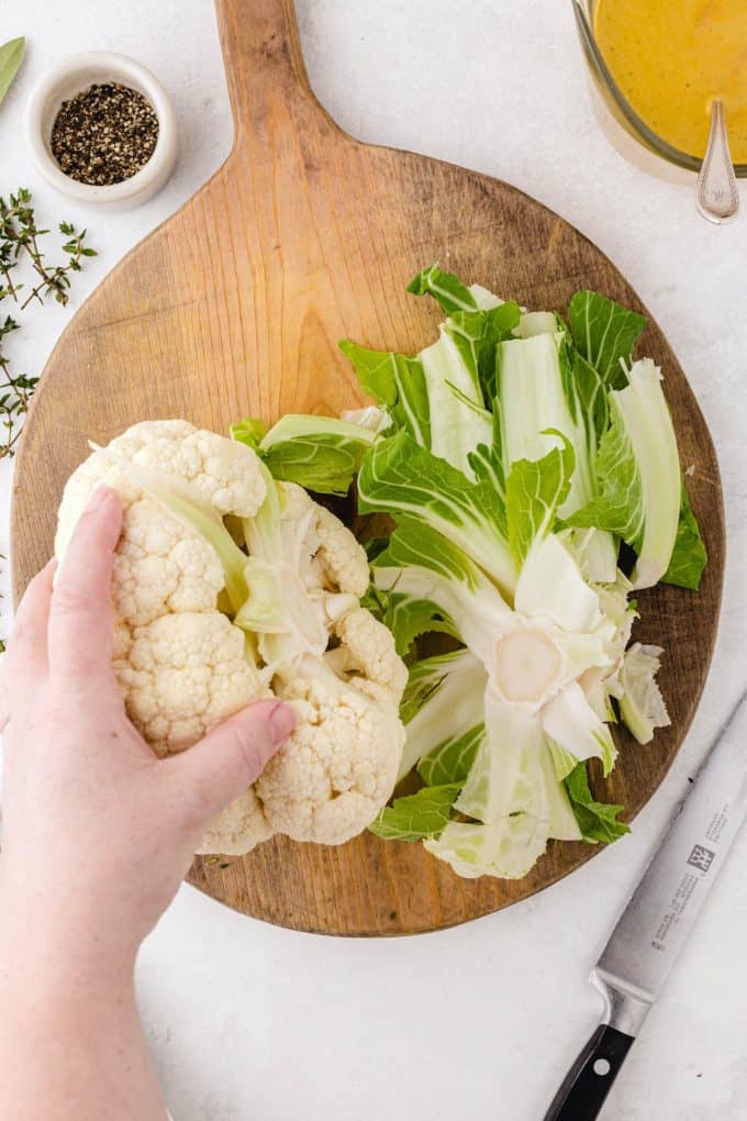 removing the leaves and base stem of the cauliflower
