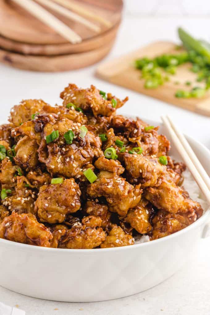 sesame chicken in a bowl of rice