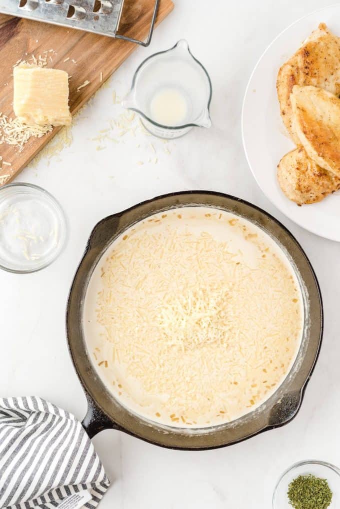 adding parmesan cheese into the pan
