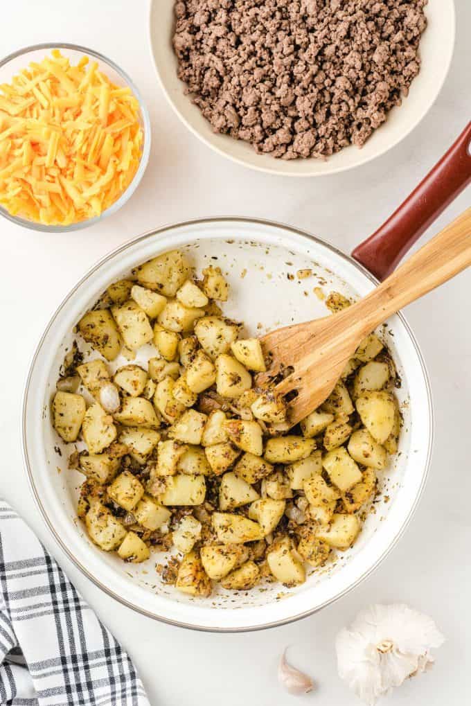 cooking potatoes until brown in a pan