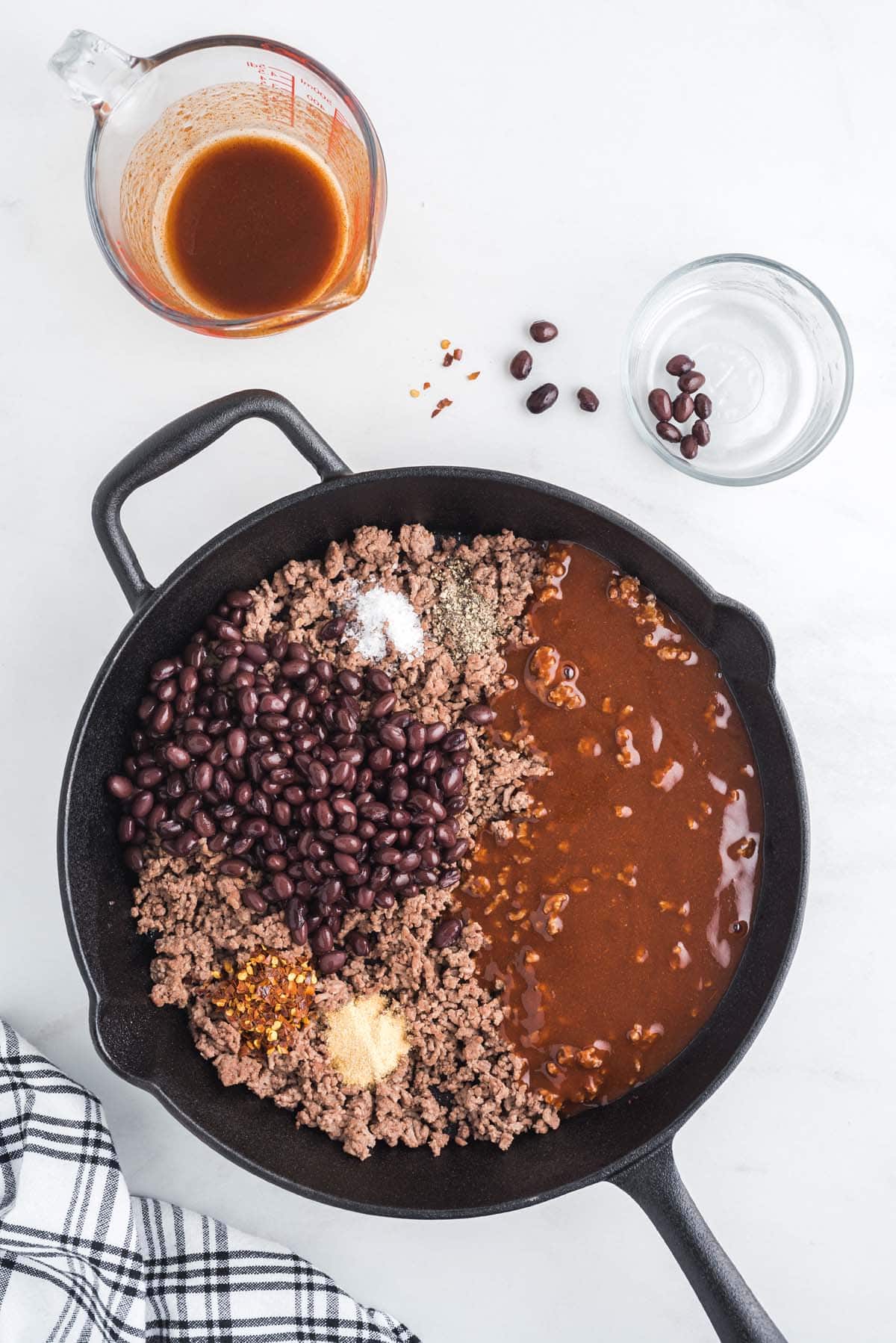 black beans, sauce, and seasonings in a pan