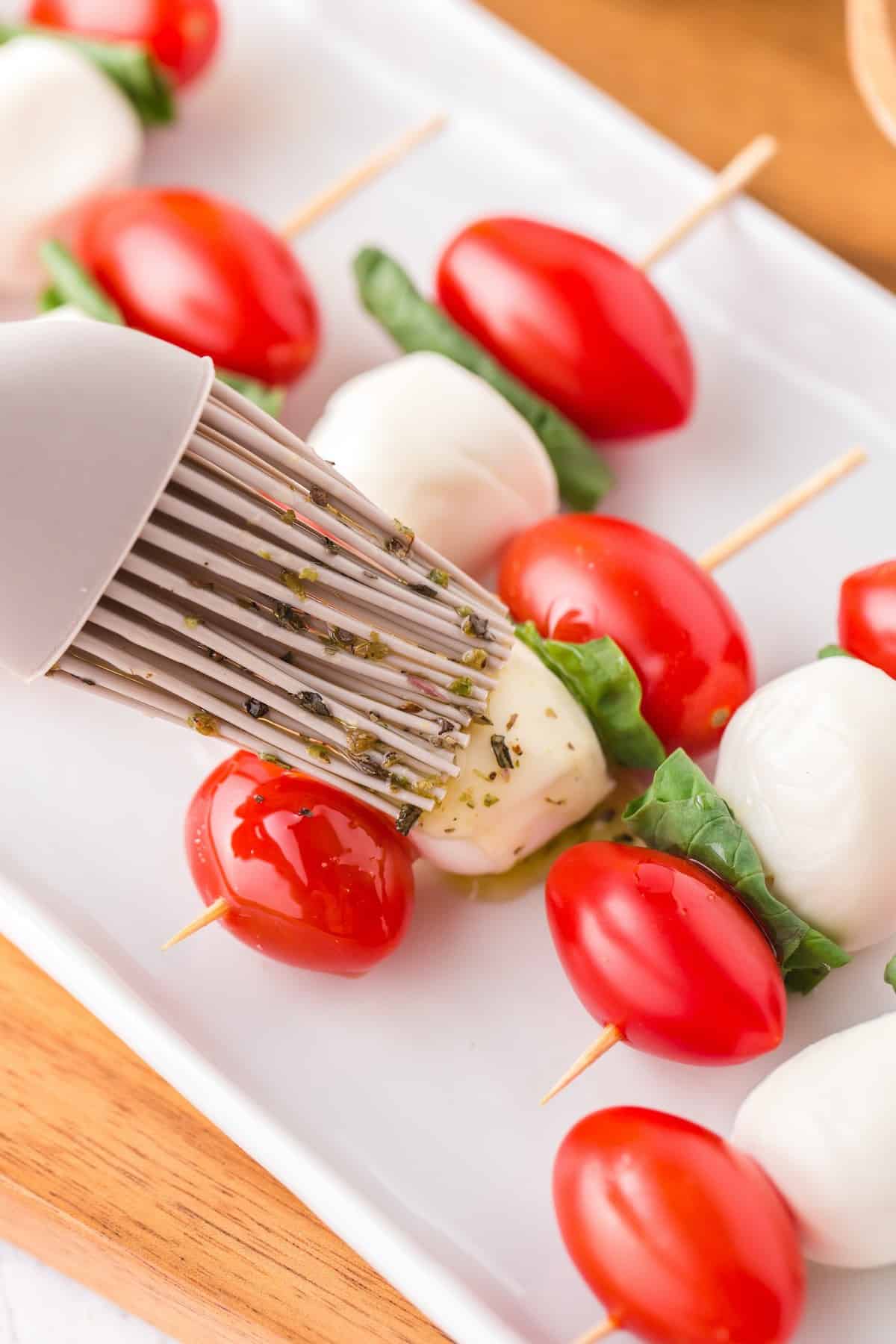 Brush the olive oil mixture over the top of the skewers.