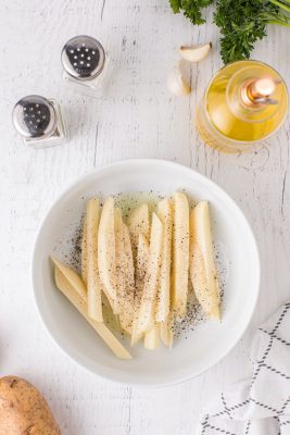 Mix fries with oil, salt and pepper.