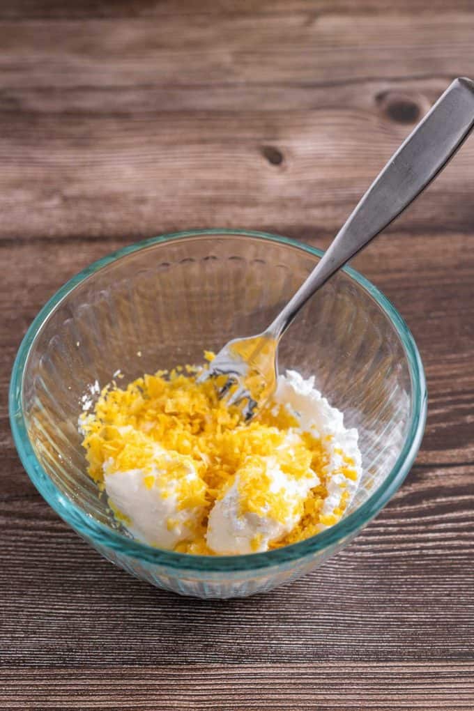 Combine cream cheese, powdered sugar, and lemon zest in a small bowl