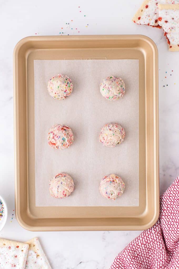 rounded balls of dough on baking sheet