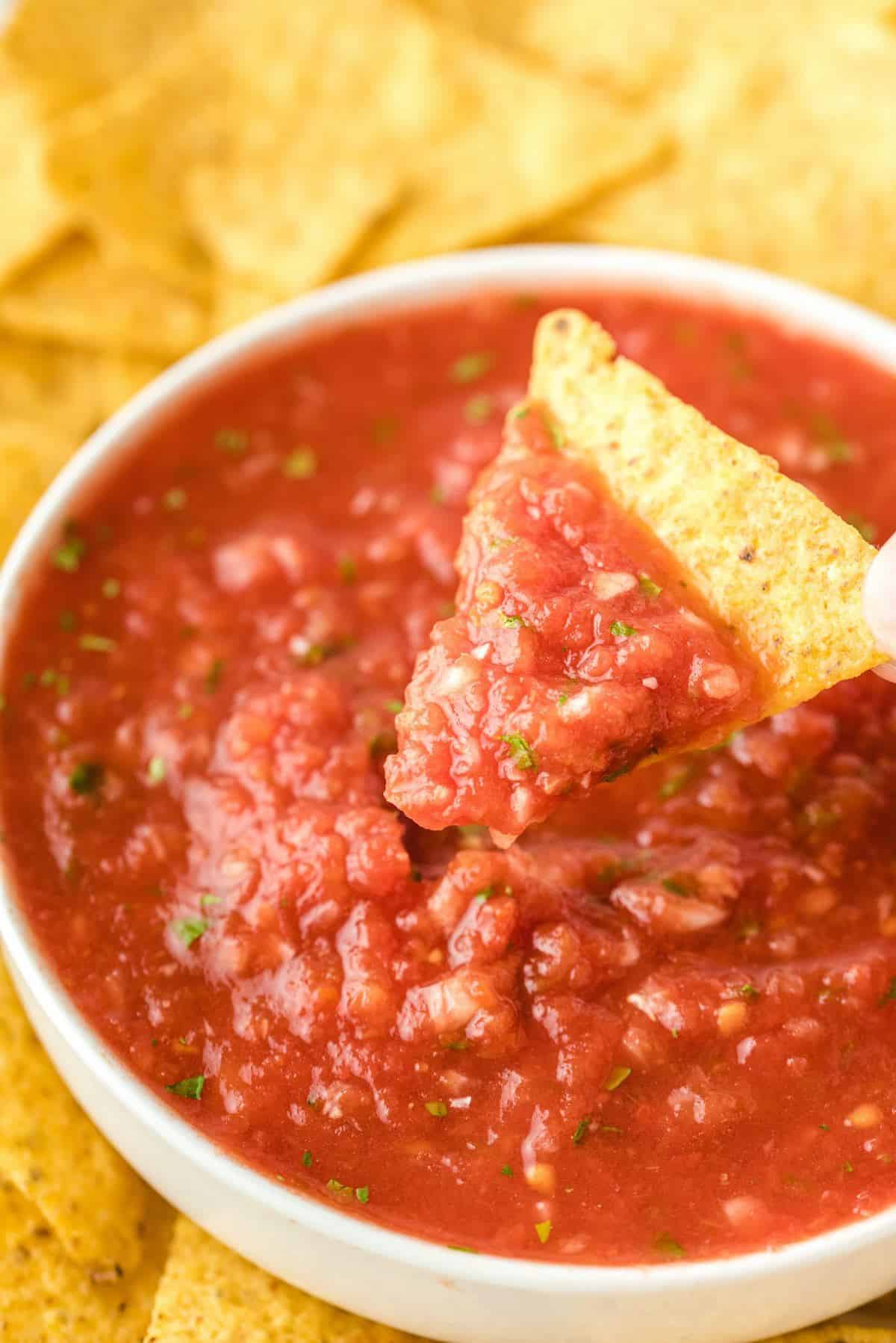 tortilla chips dipped in salsa