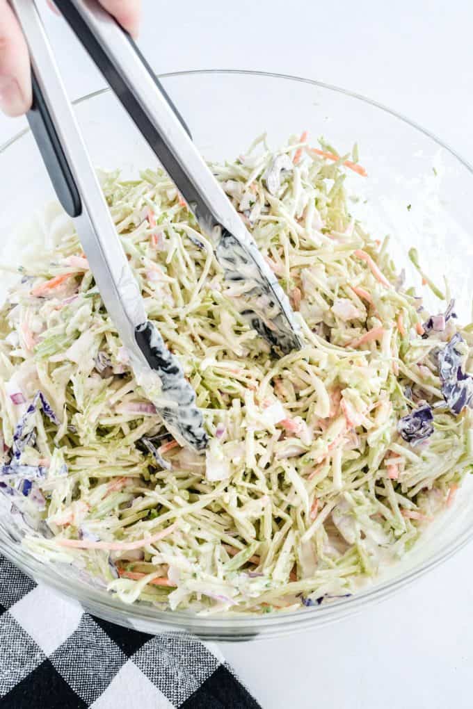 Use tongs to “toss” the salad until it is well dressed.