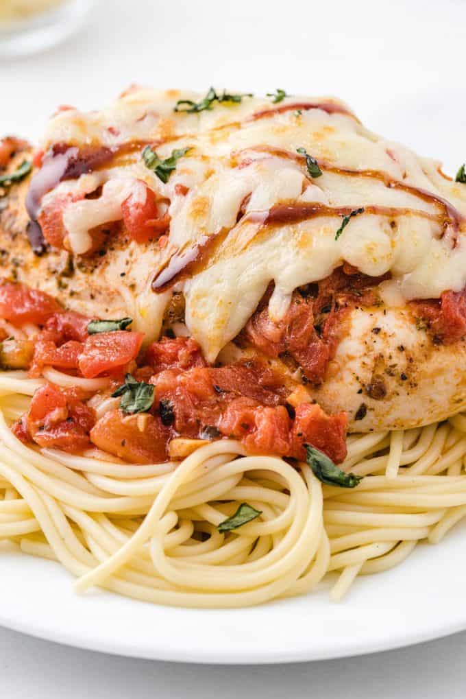 bruschetta chicken with spaghetti on a plate