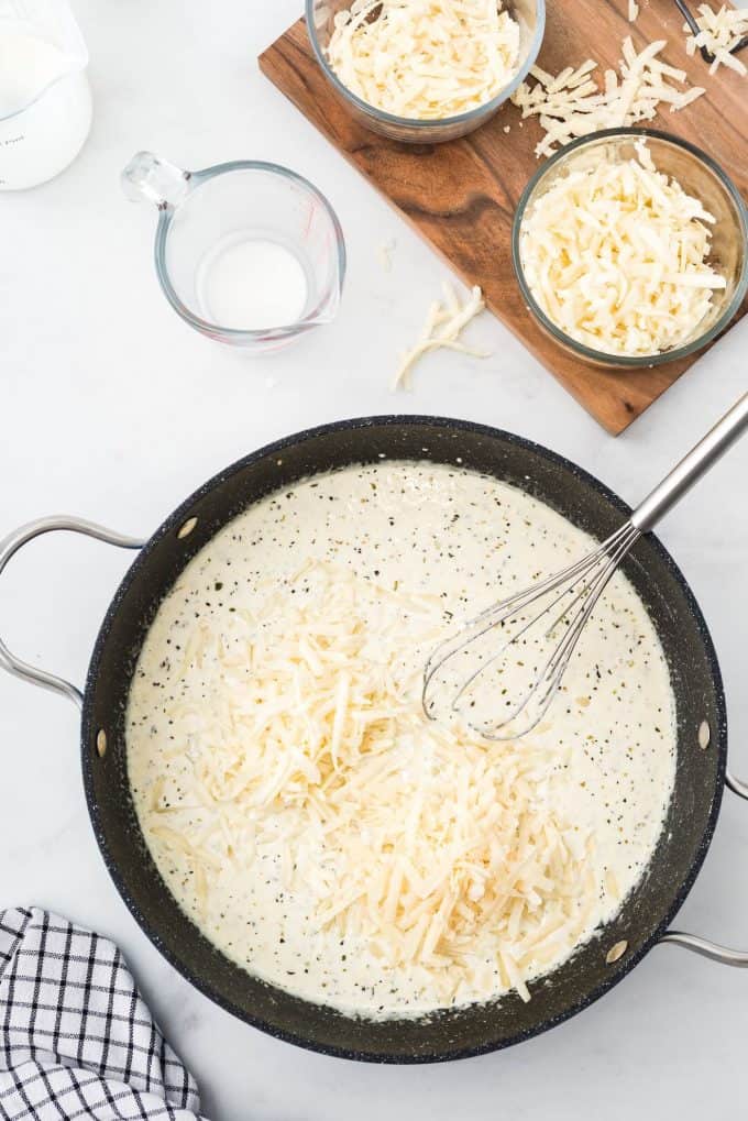 add mozzarella and parmesan cheese to the pan