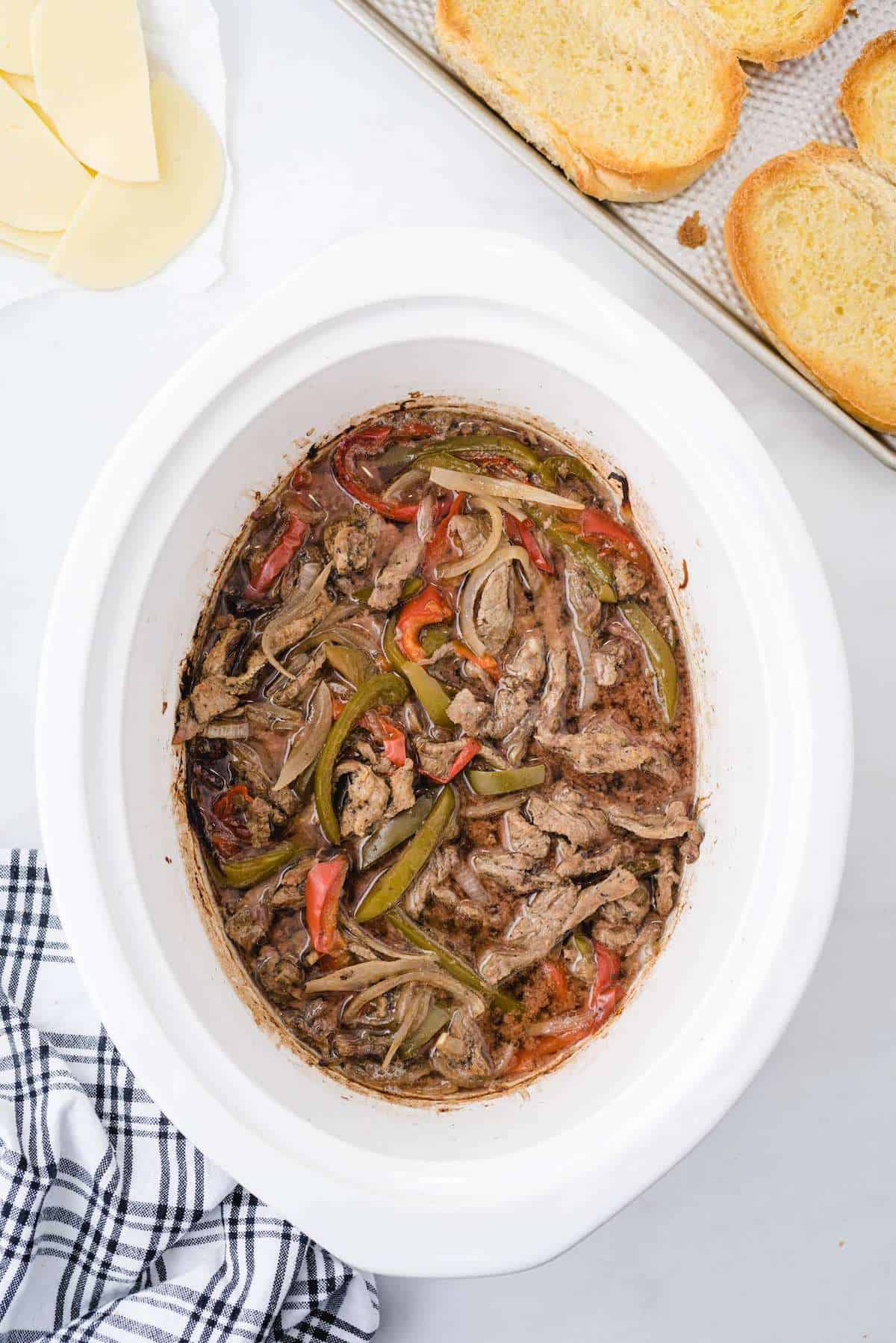 cooked beef strips, red and green peppers, and onions