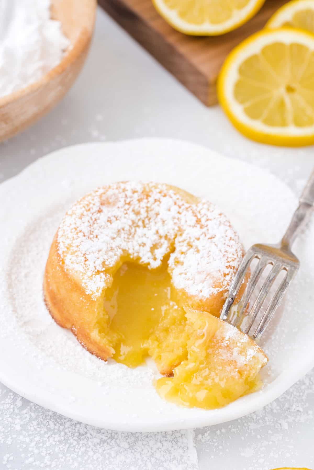 lemon lava cake on a plate with a fork