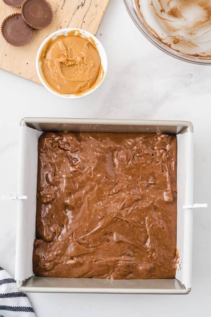 pour the brownie batter into lined baking dish