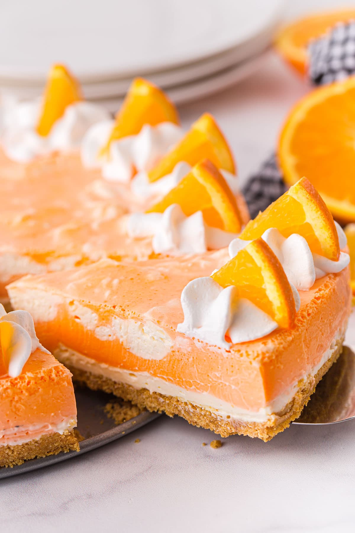 taking a slice out of orange creamsicle cheesecake. 