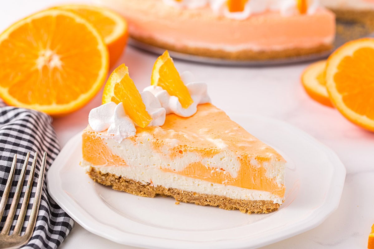 a slice of Orange creamsicle cheesecake on a plate. 