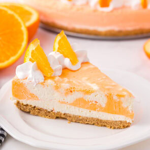 Orange creamsicle cheesecake on plate.