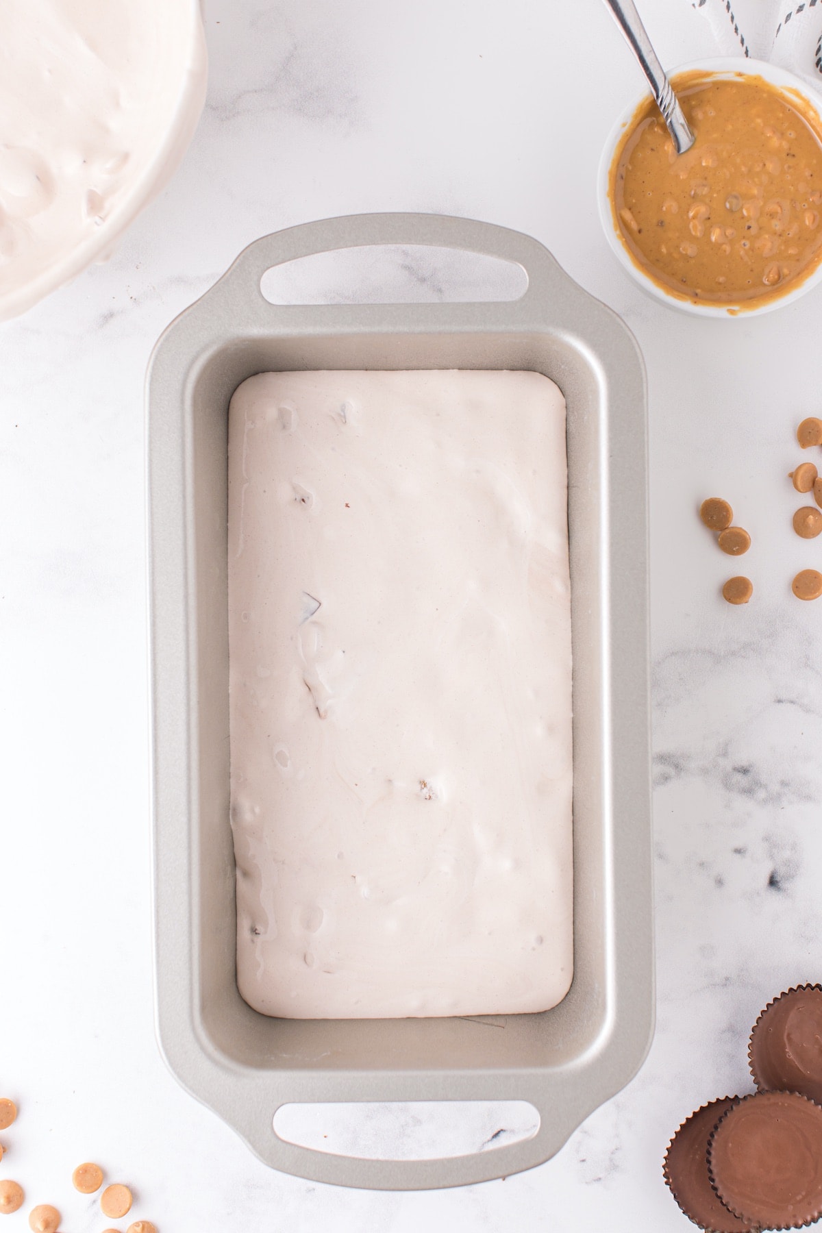 Pour half of the ice cream mixture into a prepared loaf pan