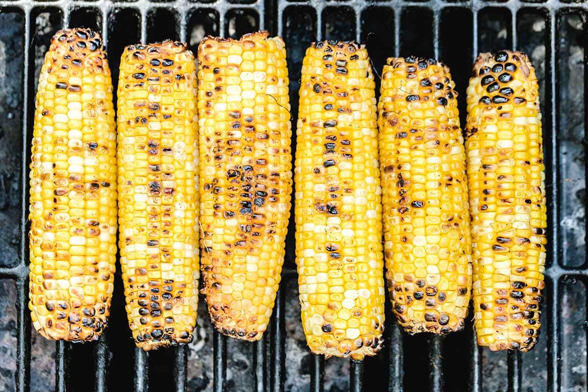 6 grilled corn on top of the grill. 