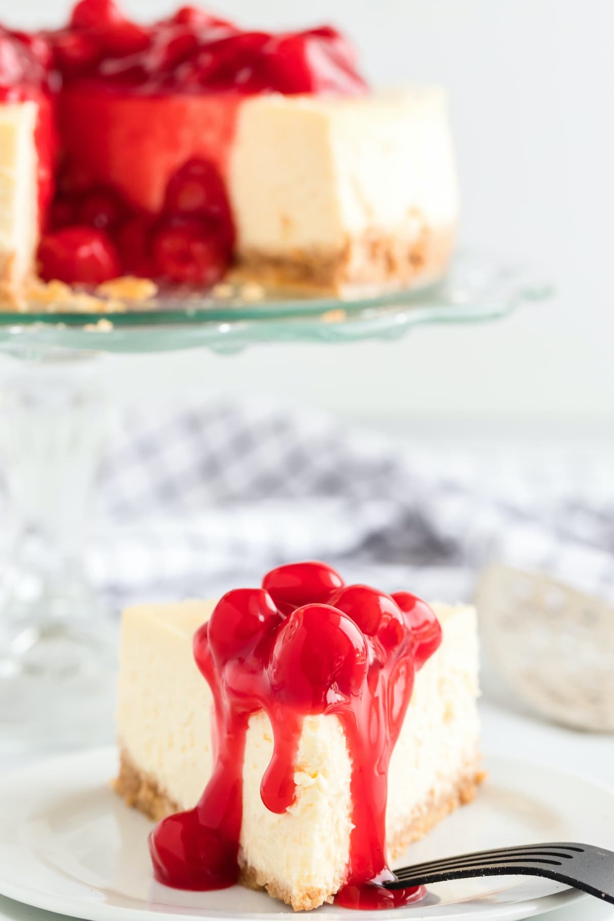 a slice of cheesecake with cherry topping