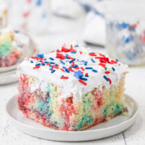 a slice of red white blue poke cake on a plate.