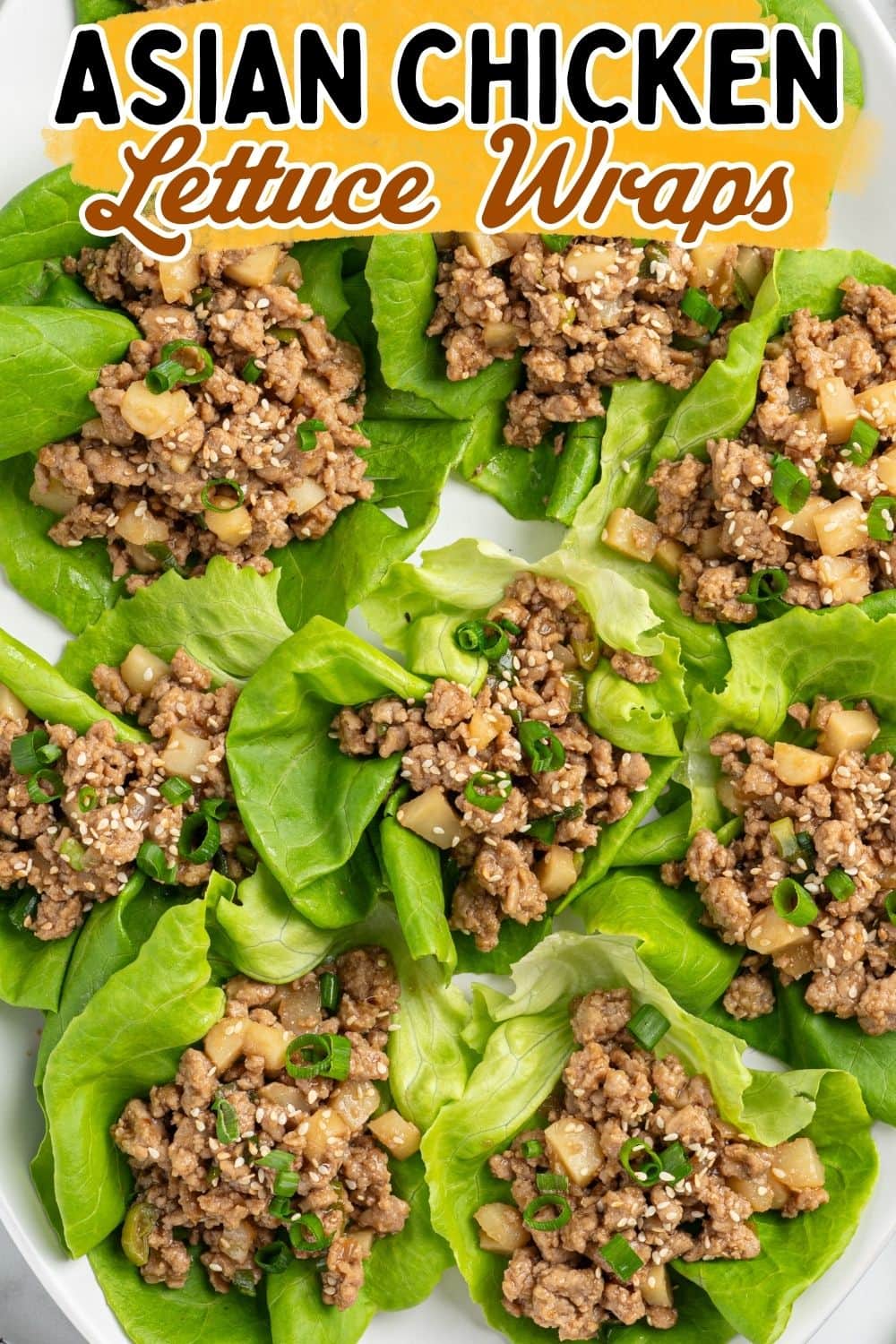 Overhead view of lettuce cups filled with seasoned ground chicken, water chestnuts, and green onions.
