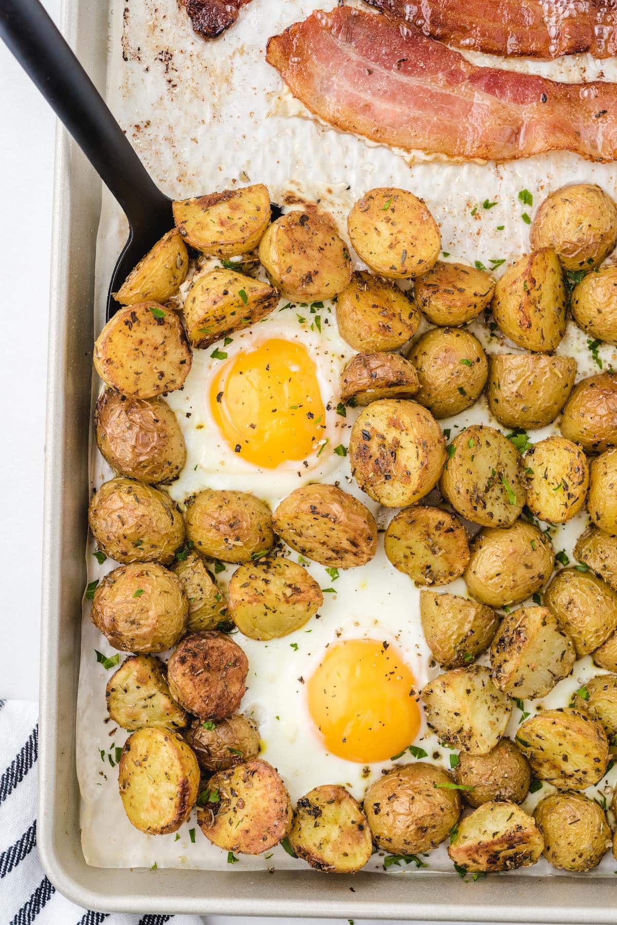 sunny side up eggs surrounded with baked potatoes
