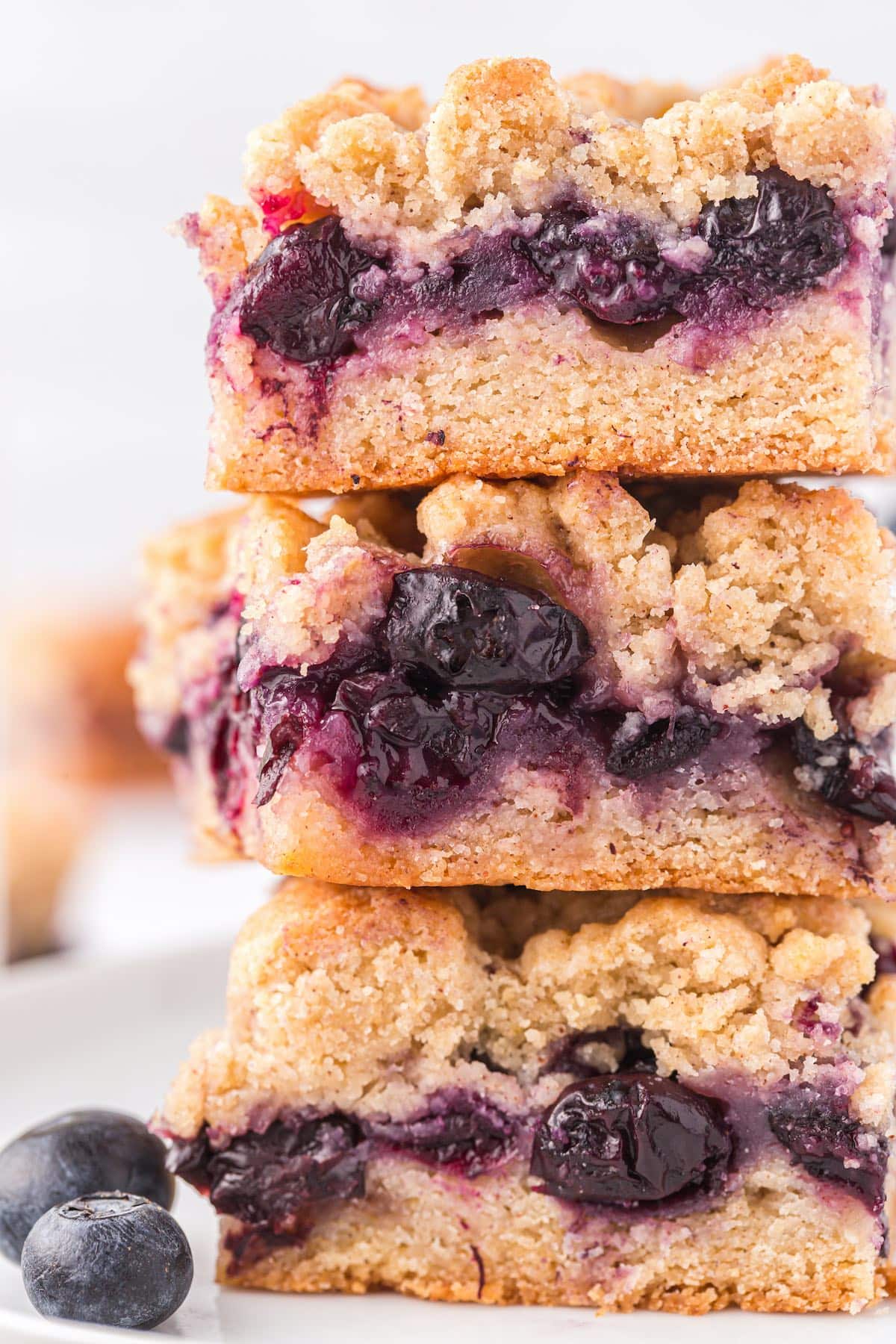 zoomed in picture of stacked blueberry crumb bars