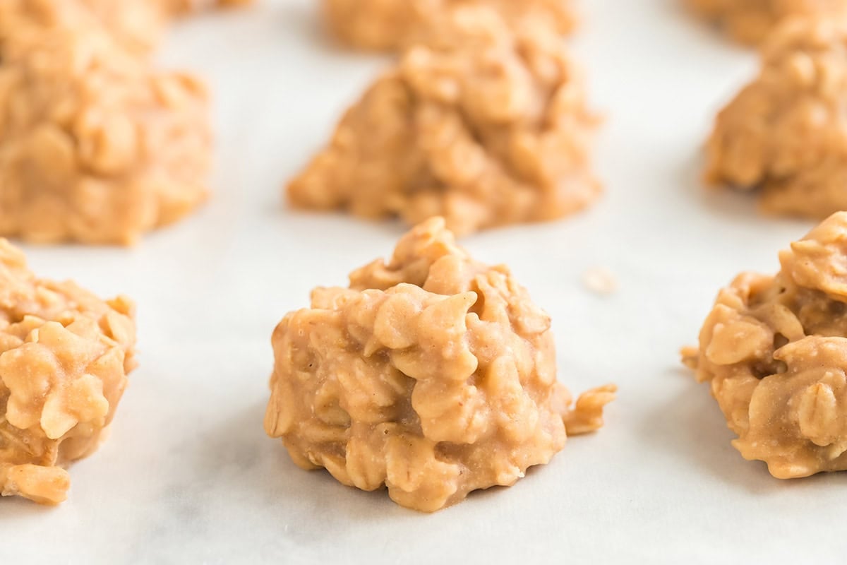 a couple of peanut butter no bake cookies scattered on the table.