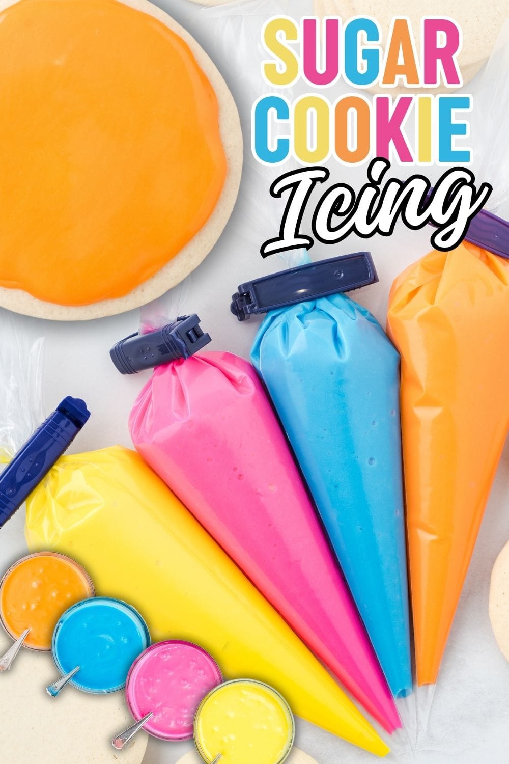 yellow, pink, blue and orange sugar cookie icing in a piping bag.. yellow, pink, blue and orange sugar cookie icing in a sauce bowl