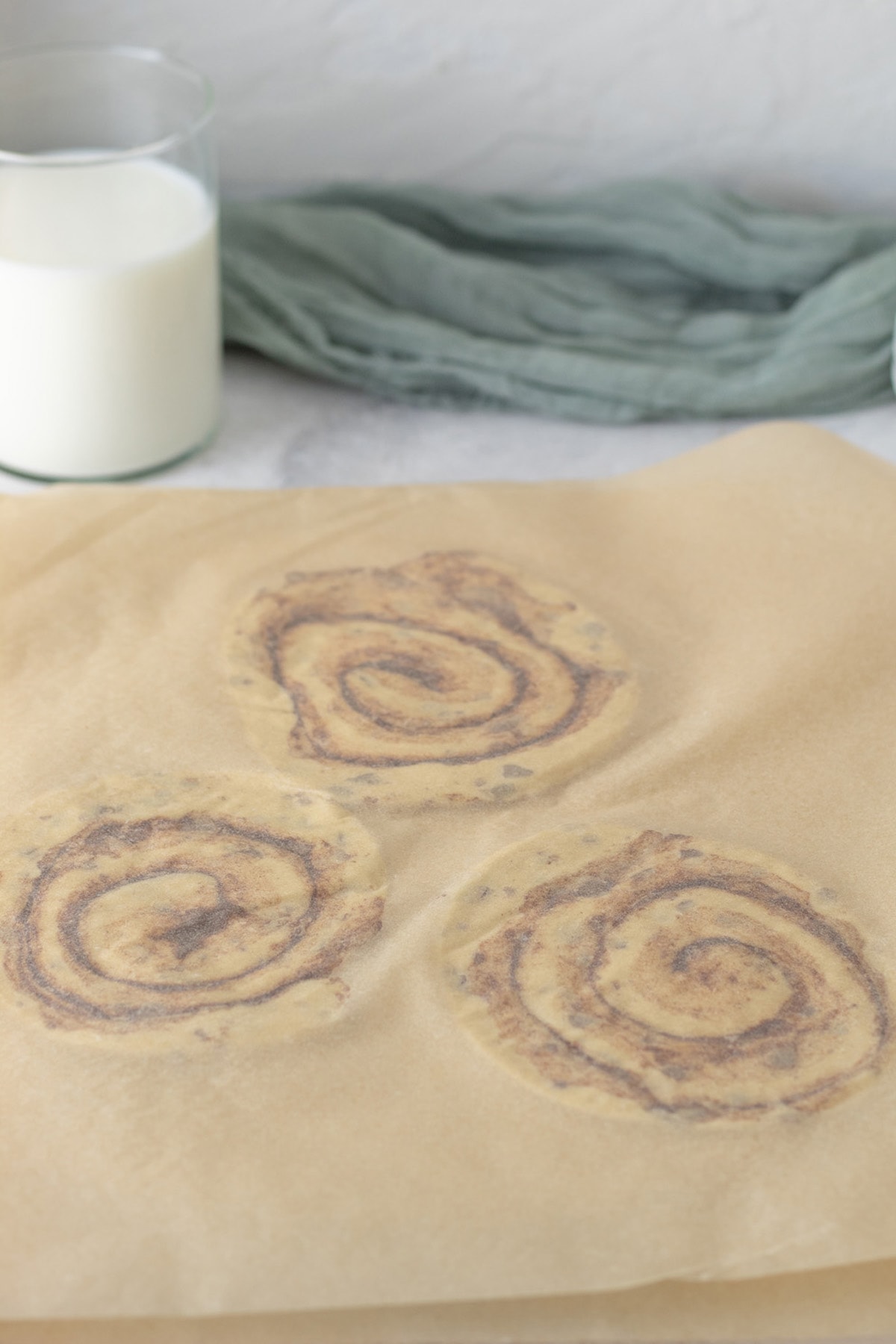 Roll out each cinnamon roll with a rolling pin until flattened out