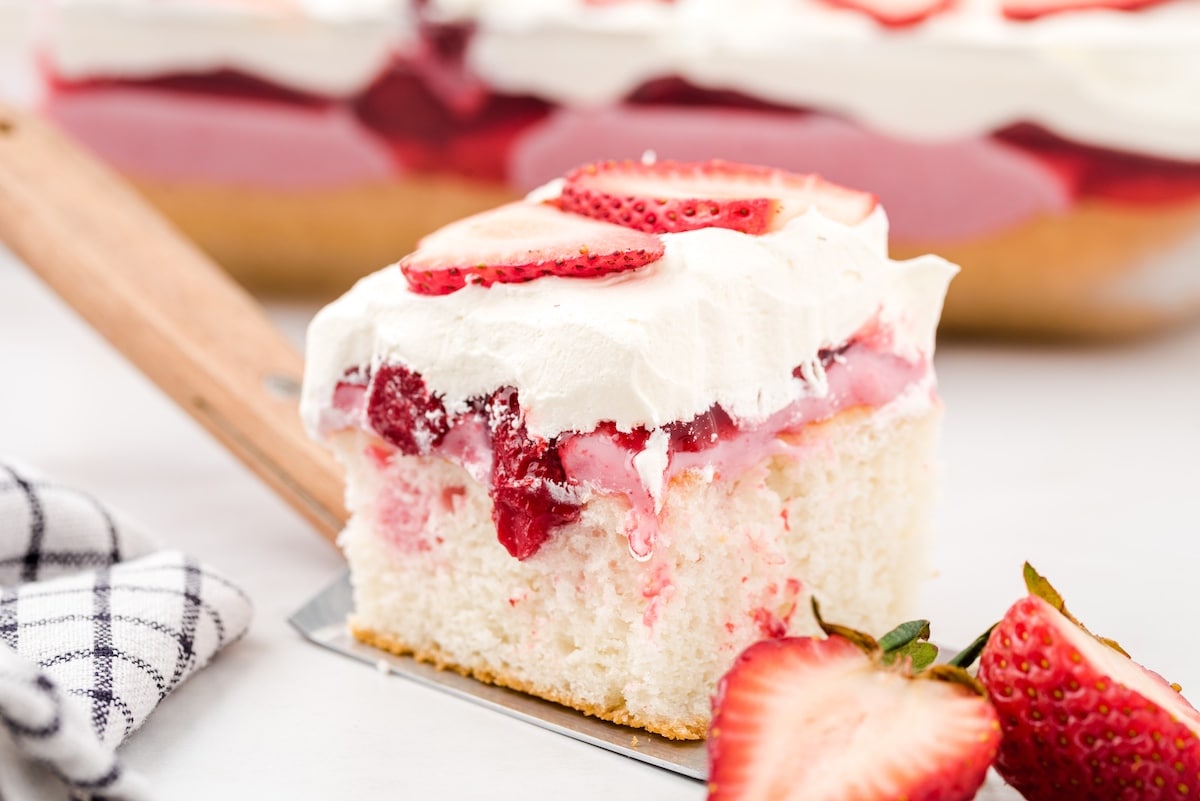 a slice of strawberry poke cake