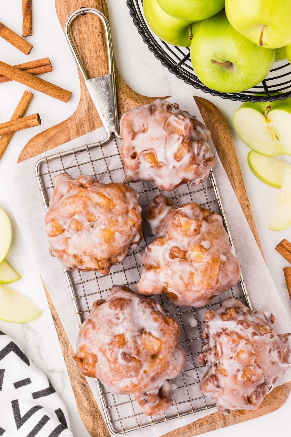 apple fritter on top of wooden board. 