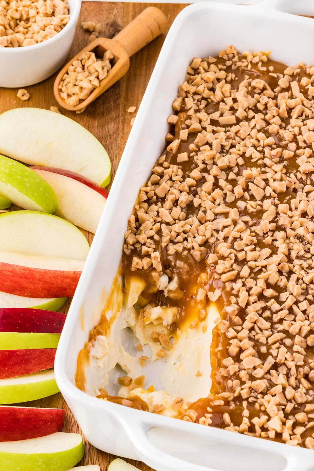 caramel apple dip served with apple slices on the side.