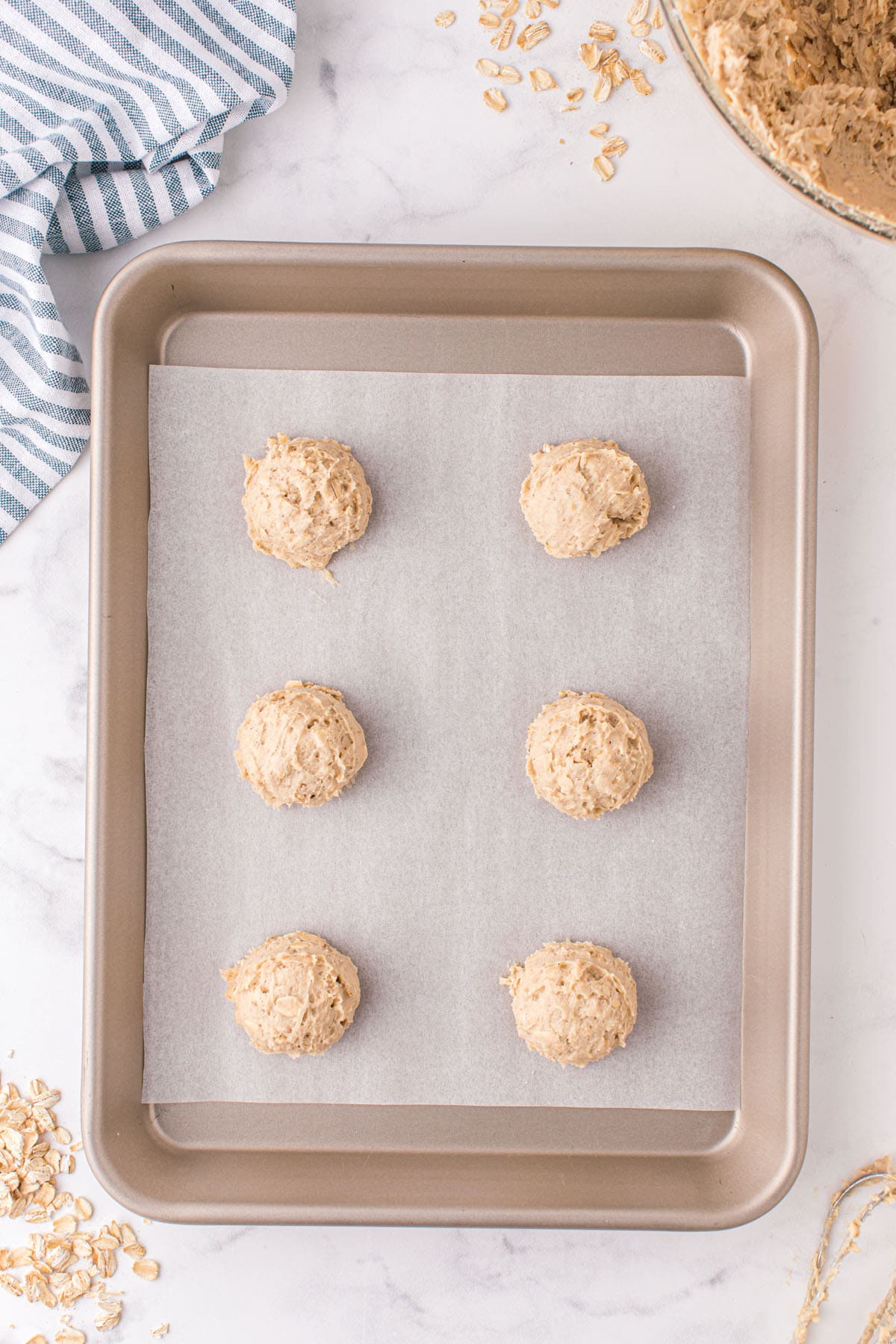 scoop of cookie dough on top of baking sheet